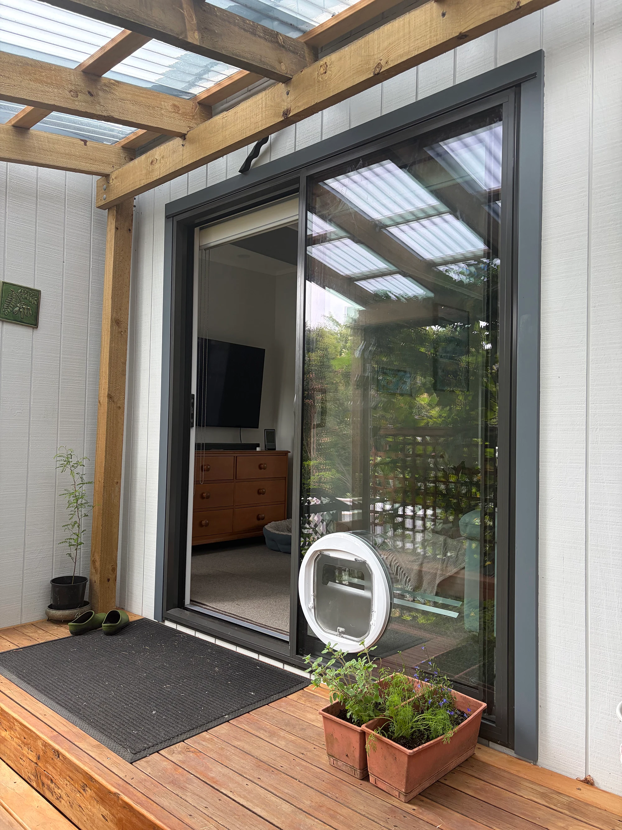 Completed aluminium sliding door under timber pergola